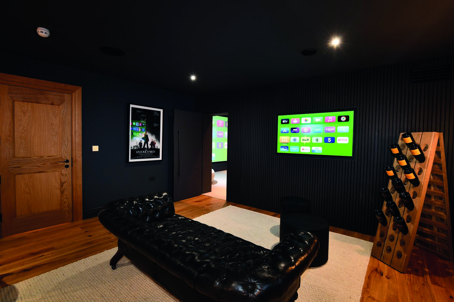A foyer area outside the main cinema room provides additional entertaining space for big game nights without missing any of the sporting action