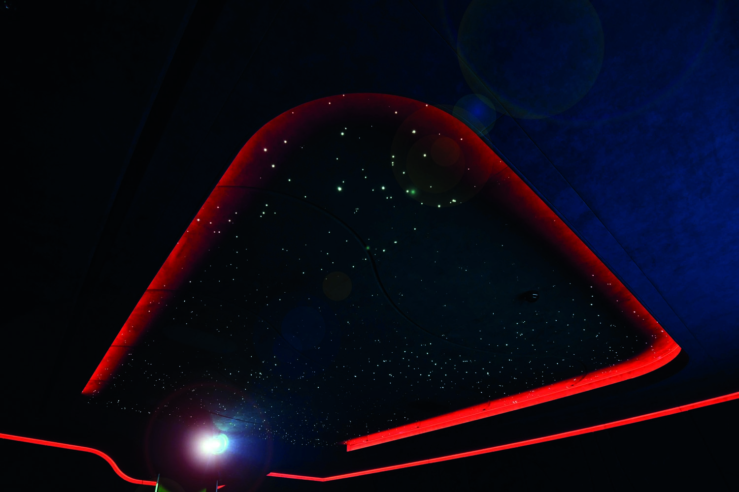 The custom-made starfield ceiling even has randomly-generated shooting stars